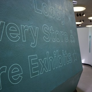 Contemporary Museum Lobby with Textured Teal Wall Typography