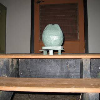 Green Vase on Wooden Table