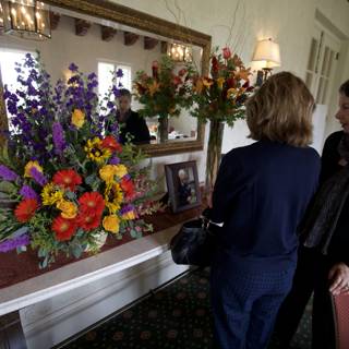 Women Admiring Flower Arrangements in Memory of Grandma
