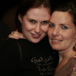 Two Friends Share a Warm Embrace at Party