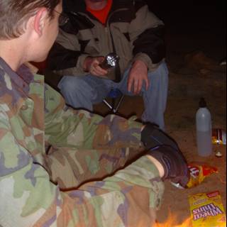 Man Enjoying a Bonfire with a Bottle in Hand