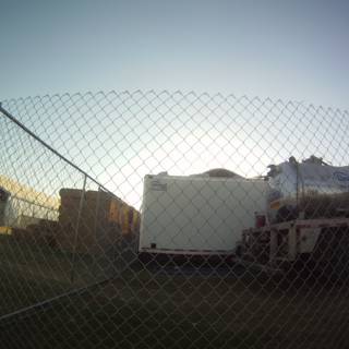 Parked Truck Behind Chain Link Fence