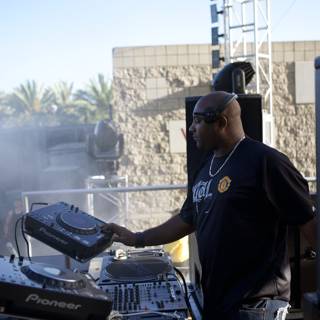 DJ mixes the beat under the sunny skies