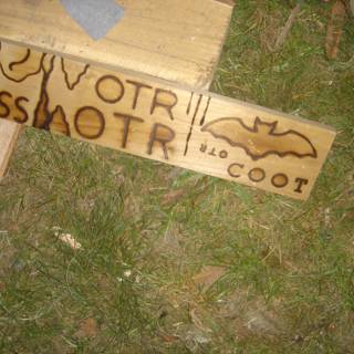 Wooden Sign with Bat Symbol