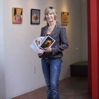 Woman in Jeans and Blazer Reading Book in Art Gallery