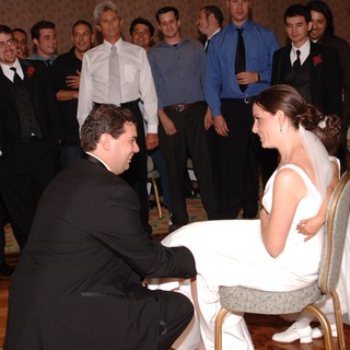 Groom Removes Garter at Lively Wedding Reception