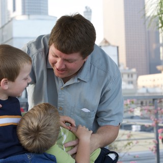 Father Shares a Tender Moment with Two Sons