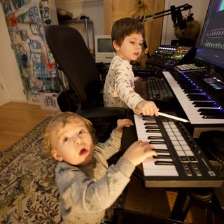 Two Young Brothers Making Music Together at Home Studio