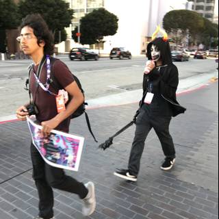 Two Men Walking Down a Street with a Skateboard