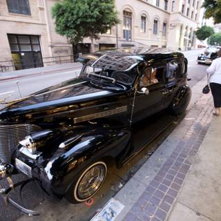 Black Convertible Hot Rod Parked on a Sidewalk