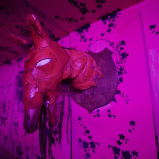 Red Sculptural Horse Head in Magenta-Lit Gallery
