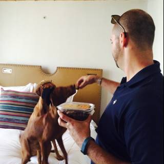 Man Feeds Best Friend on the Bed