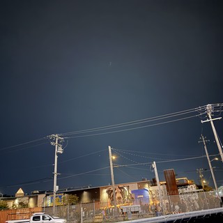 Urban Night Scene with Power Lines and Industrial Buildings