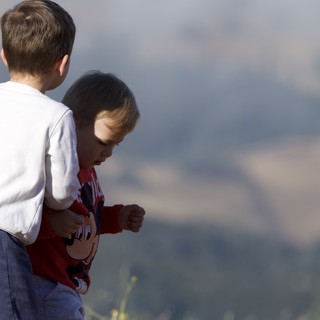 Two Young Brothers Share a Tender Outdoor Moment