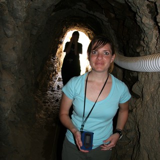 Explorer Inside Ancient Rocky Mine Tunnel Passage