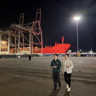 Night Stroll at Industrial Port with Red Ship