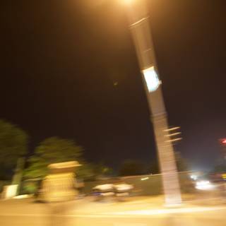 Blurry Street Light Illuminates Night Road