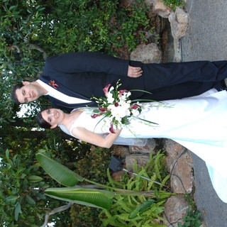 Bride and Groom Pose in Lush Garden Setting