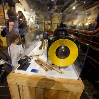 Museum Display Case with Vintage Yellow Record and Scientific Instruments