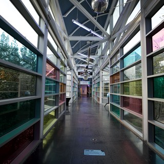 Modern Glass Corridor with Colorful Reflections at Science Center