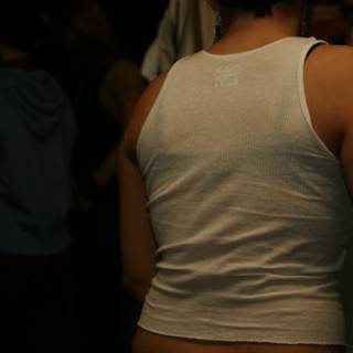 Back of a woman in white tank top