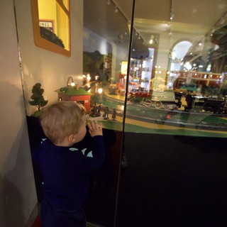Young Child Mesmerized by Vintage Train Display