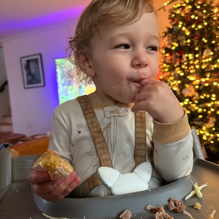 Toddler Enjoying Christmas Dinner at Holiday Table