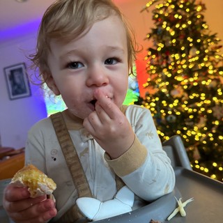 Toddler Enjoying Christmas Dinner at Festive Table