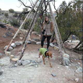 Woman and Dog Admiring Teepee in the Wilderness