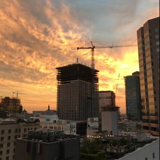 Cityscape Sunset with Construction Cranes