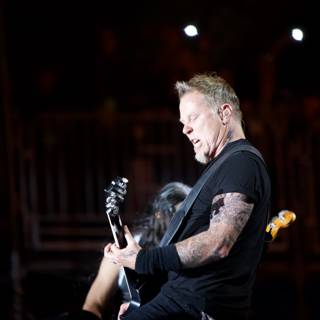 James Hetfield rocks the stage with his guitar and tattoos