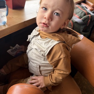 Young Child in Beige Outfit at Home