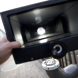 Opening the Grill Lid on an Outdoor Deck