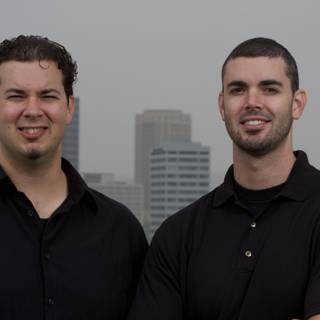 Dan and Dave, Smiling in Front of a Skyscraper