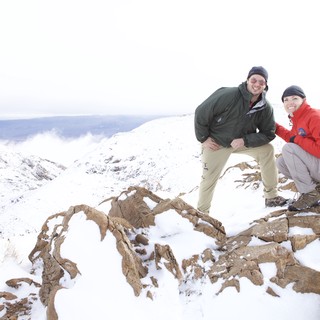 Two Hikers Celebrate Summit in Snowy Mountain Wilderness
