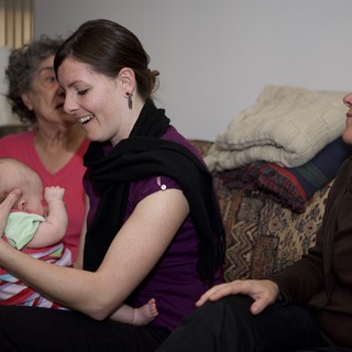 Three Generations Bonding Over a Newborn Baby