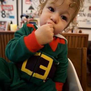 Adorable Toddler in Christmas Elf Costume at Restaurant