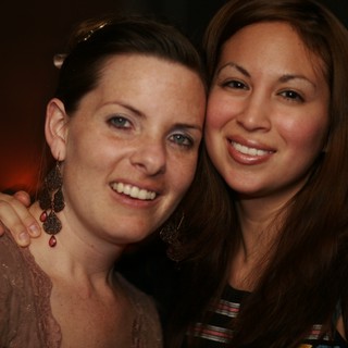 Two Friends Smiling at a Nightclub Celebration