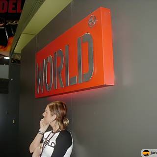 Woman Standing in Front of World Sign