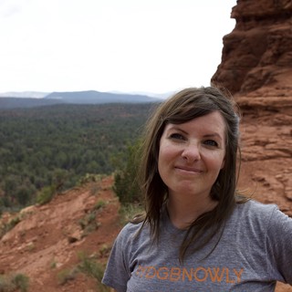Woman Smiling Atop Red Rock Formation in Sedona