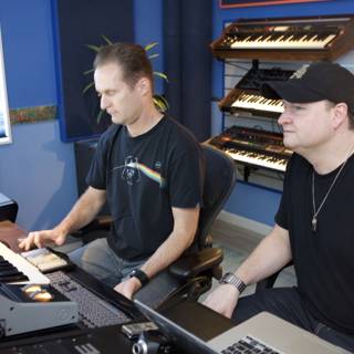 Two Men Jamming Out on Keyboards