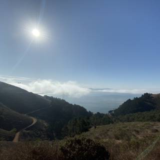 Panoramic view of sun-kissed mountains and ocean surface