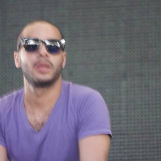 DJ Mehdi in Sunglasses and a Purple T-Shirt