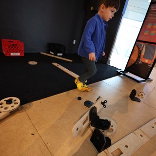 Child Exploring Interactive Science Museum Exhibit
