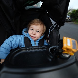 Curious Toddler Exploring Baby Stroller Controls