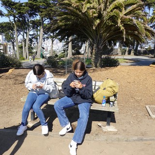 Friends on Phones in Urban Park
