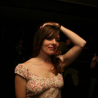 Young Woman Dancing at Dimly Lit Venue