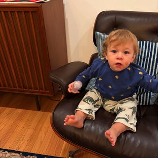 Toddler Relaxing in Vintage Leather Chair at Home