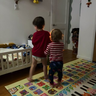 Two Young Children Playing in Colorful Bedroom