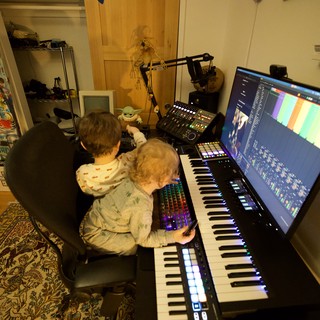 Father and Child Creating Music Together in Home Studio